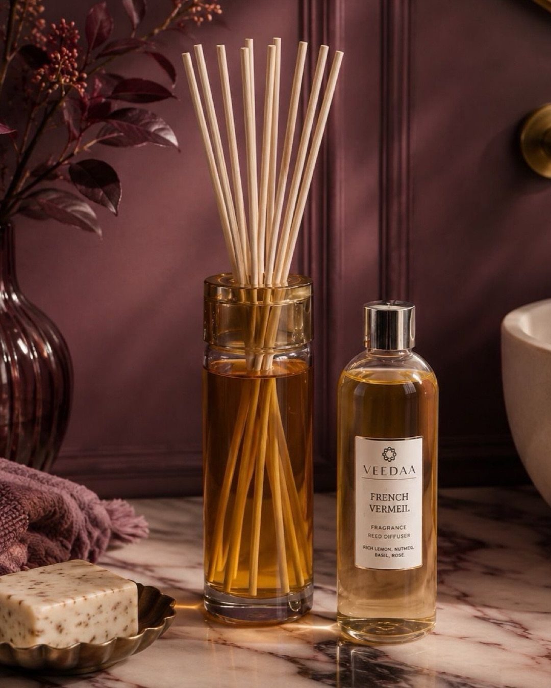 Reed diffuser bottle with wooden sticks and fragrance oil on marble surface