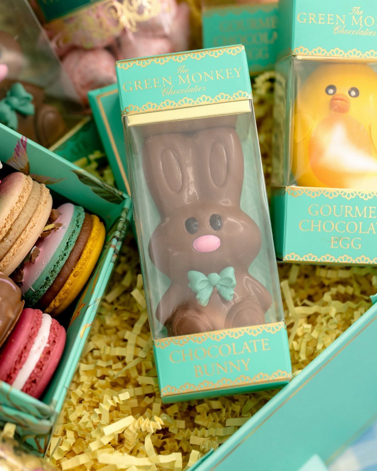 Teal Easter gift box with chocolate bunny, macarons, and a chocolate egg.