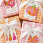 Four gingham wrapped gifts with personalized tags featuring autumn illustrations and family name.
