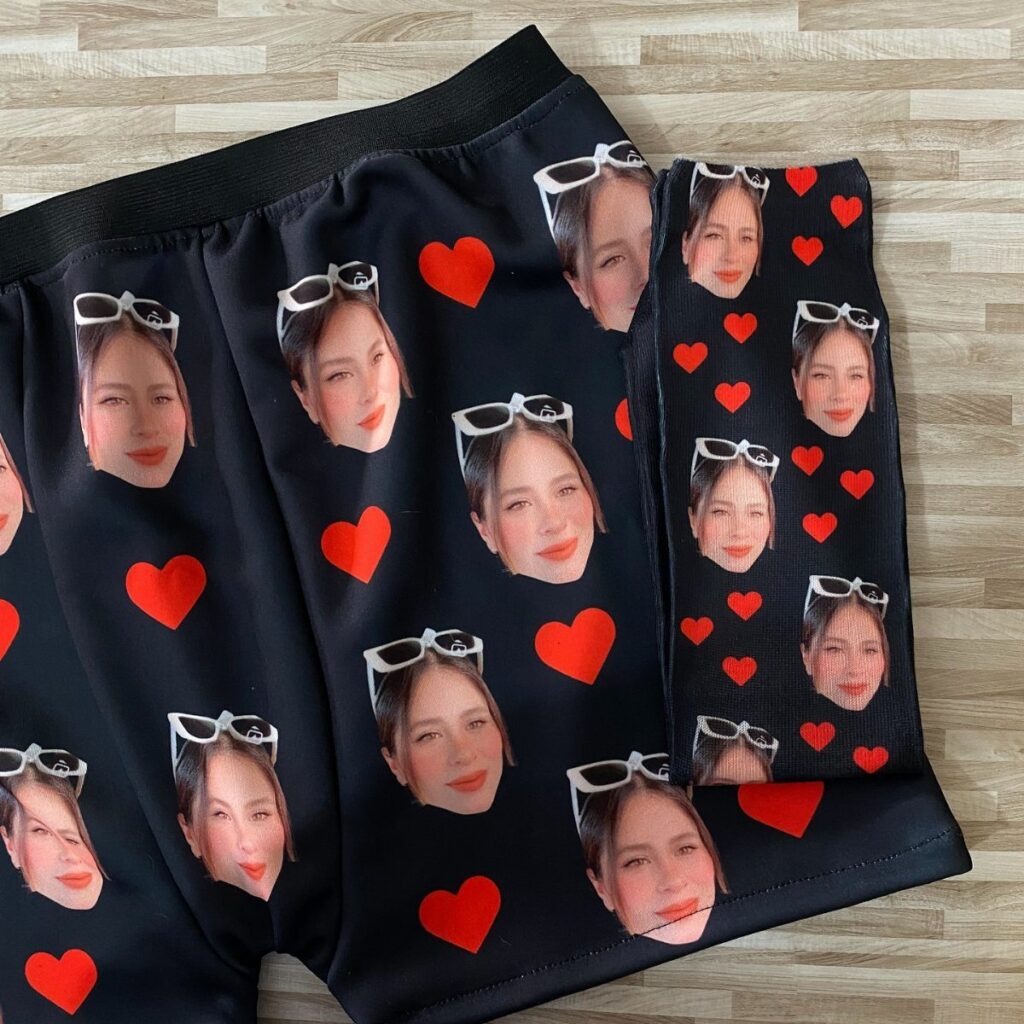 Black socks and boxers printed with a woman's face and red hearts.