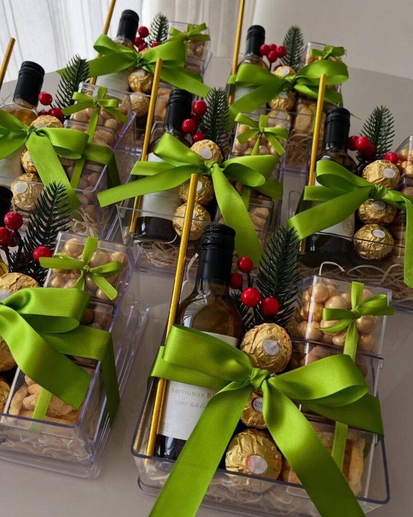 Wine gift baskets with green ribbons, chocolates, and nuts in clear packaging.