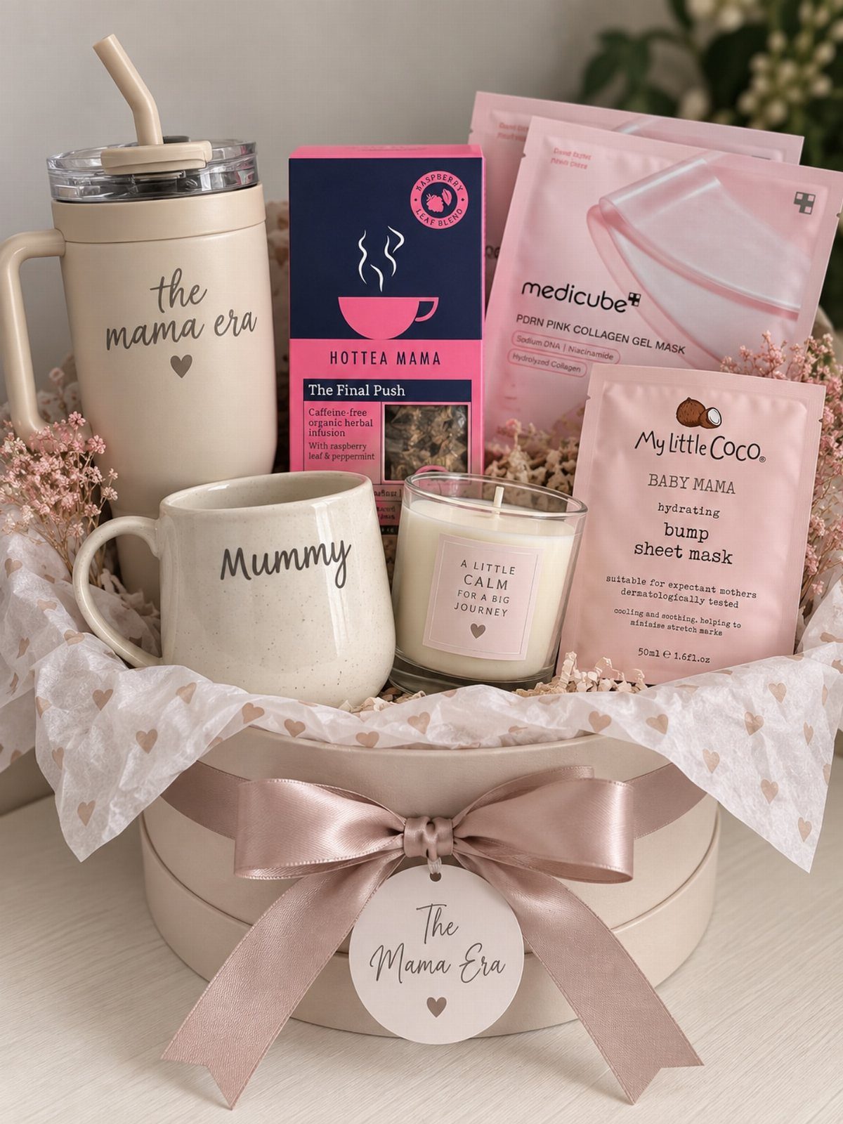Gift basket for a mother with a tumbler, mug, candle, and face masks.
