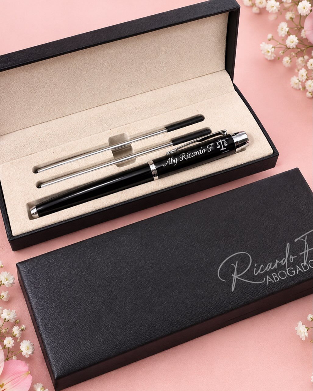 Luxury pen set in a black gift box on a pink floral background
